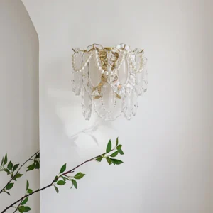 Petal Pearl Wall Light side angle view installed on interior wall with green plant accent