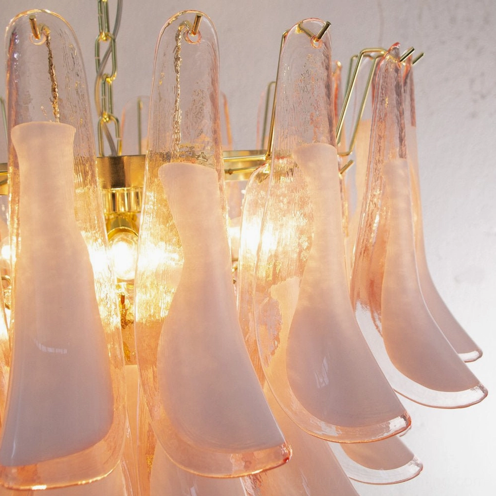 Close-up Petal Rain Chandelier detail, translucent gradient pink glass petals, lit interior