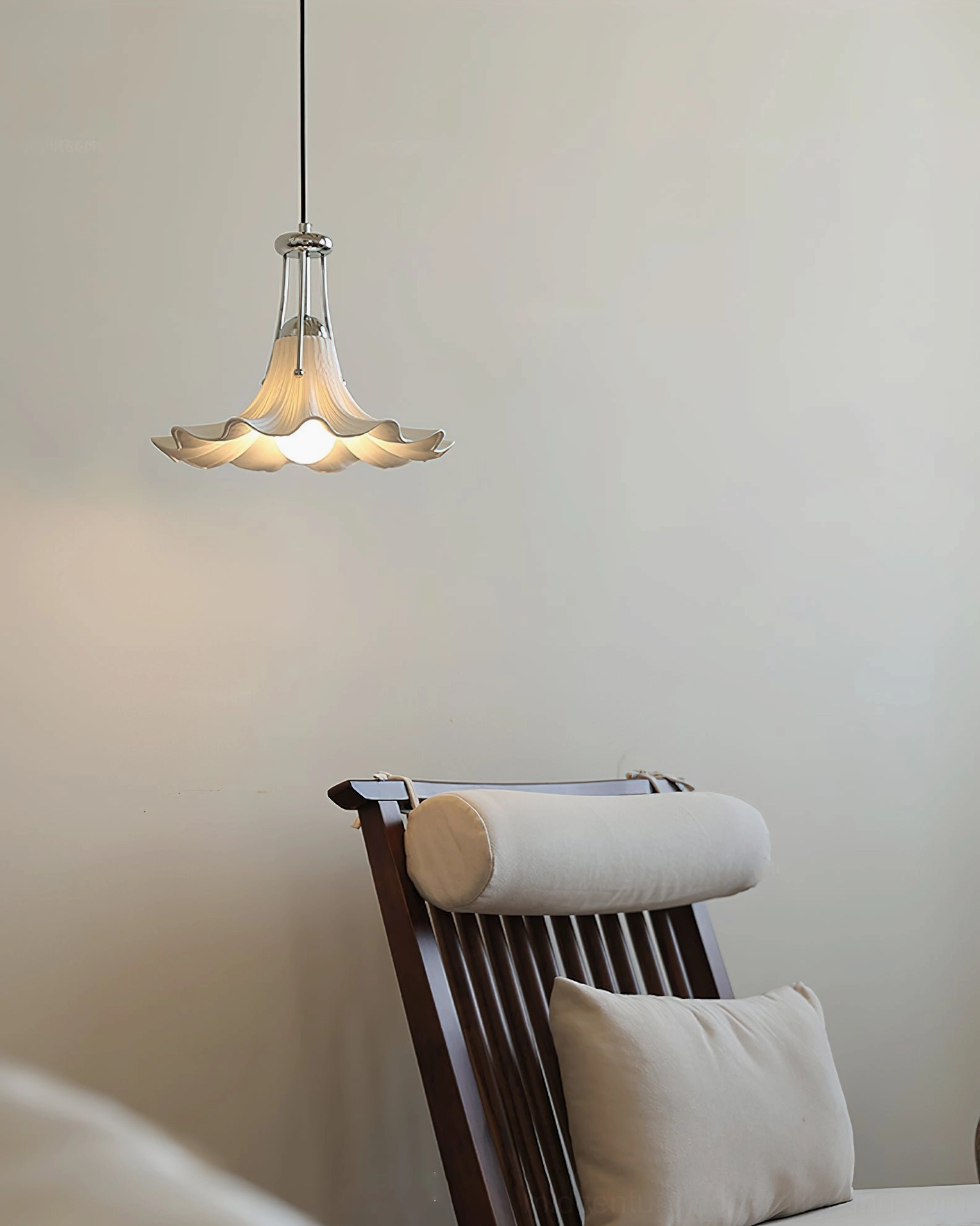 Petalia pendant light suspended at eye level in neutral living room with wooden furniture and warm lighting