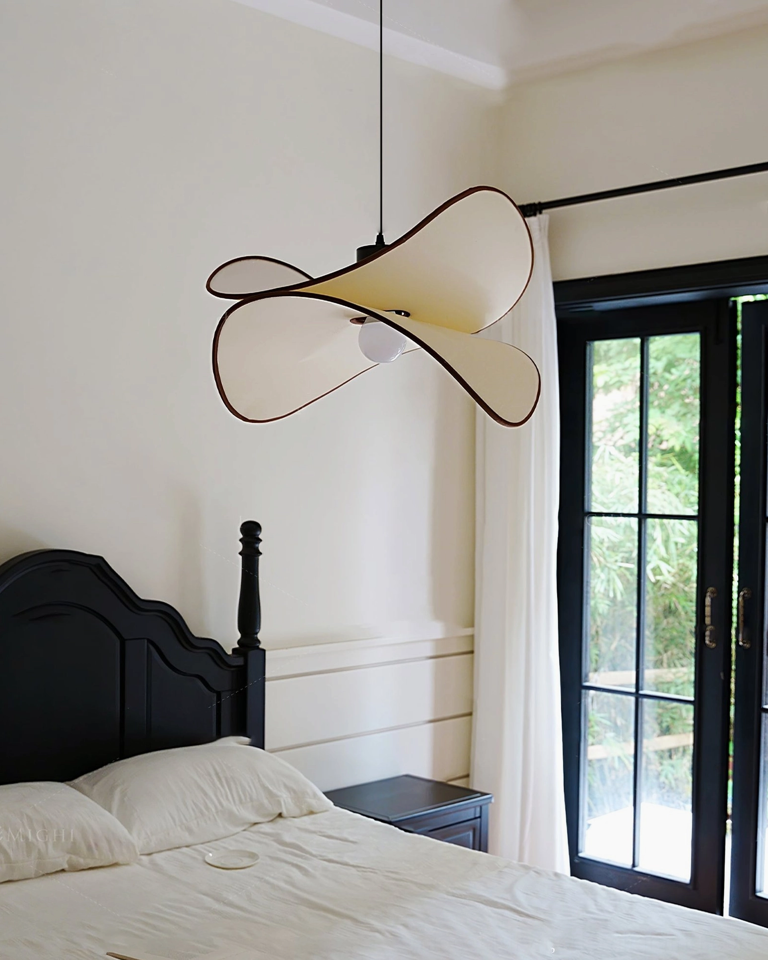 Petalo pendant lamp beside French window in vintage bedroom with black metal frame