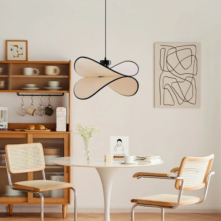 Mid-century modern Petalo pendant lamp installed in Scandinavian dining nook with wooden cabinet