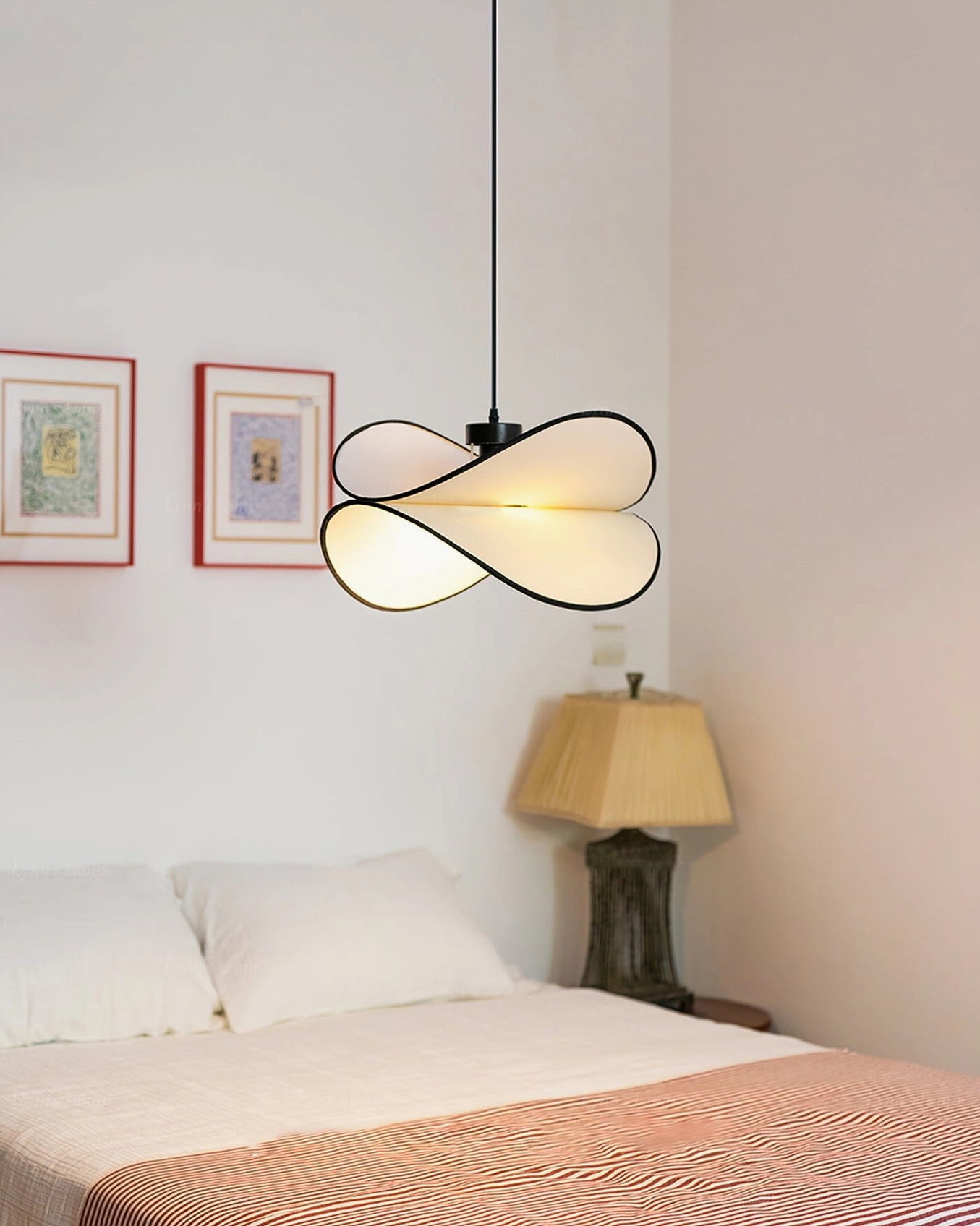 Contemporary Petalo ceiling lamp in cozy bedroom interior with pink bedding