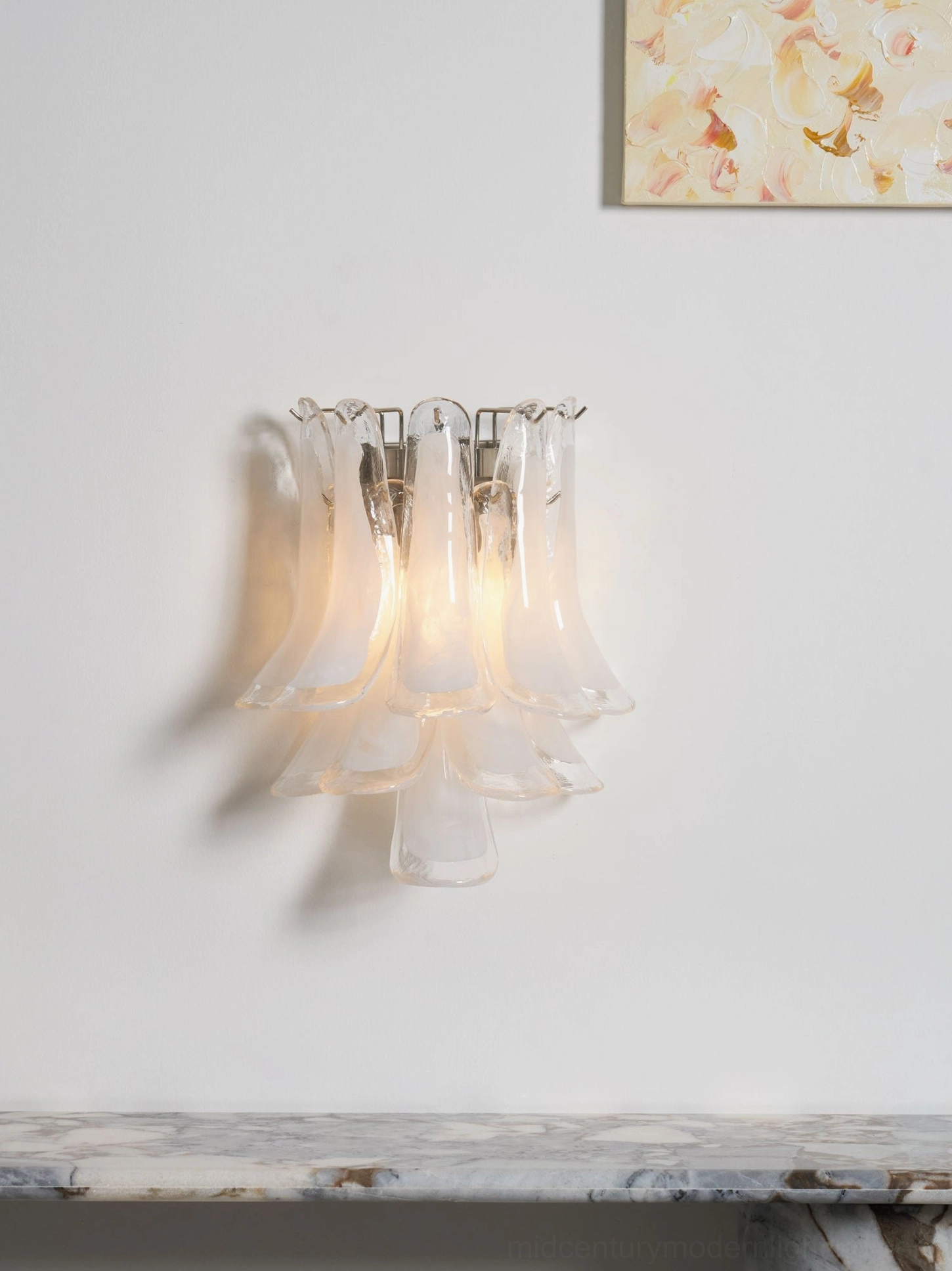 Petral wall sconce featuring hand-formed glass petals and metal mounting, modern lighting statement