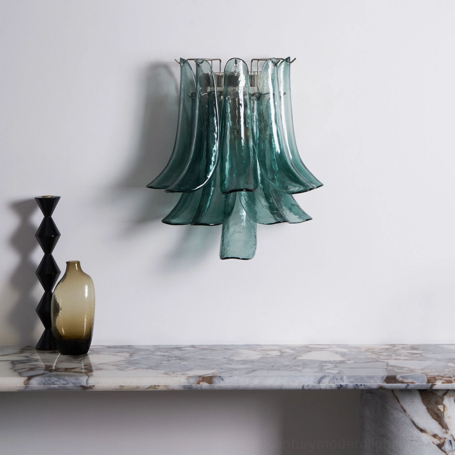 Petral handcrafted glass wall sconce with layered teal petal design, side view showcasing glass depth and sculptural form
