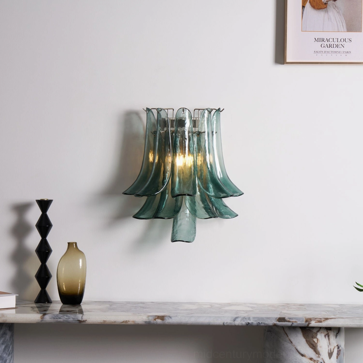 Petral wall sconce in illuminated teal green translucent glass, installed in contemporary minimalist interior with artistic ambient glow