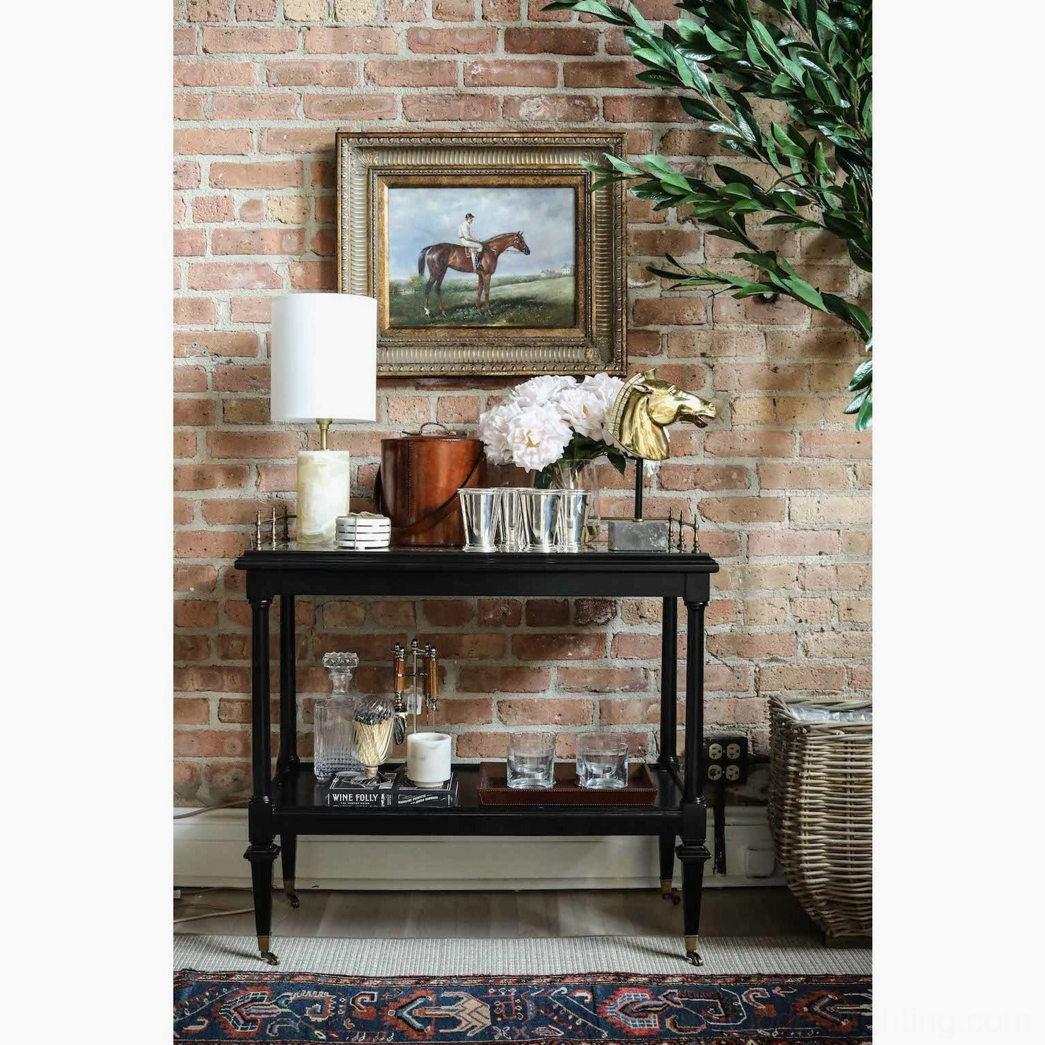 Pharos marble lamp on black console table against vintage brick wall in living bar area