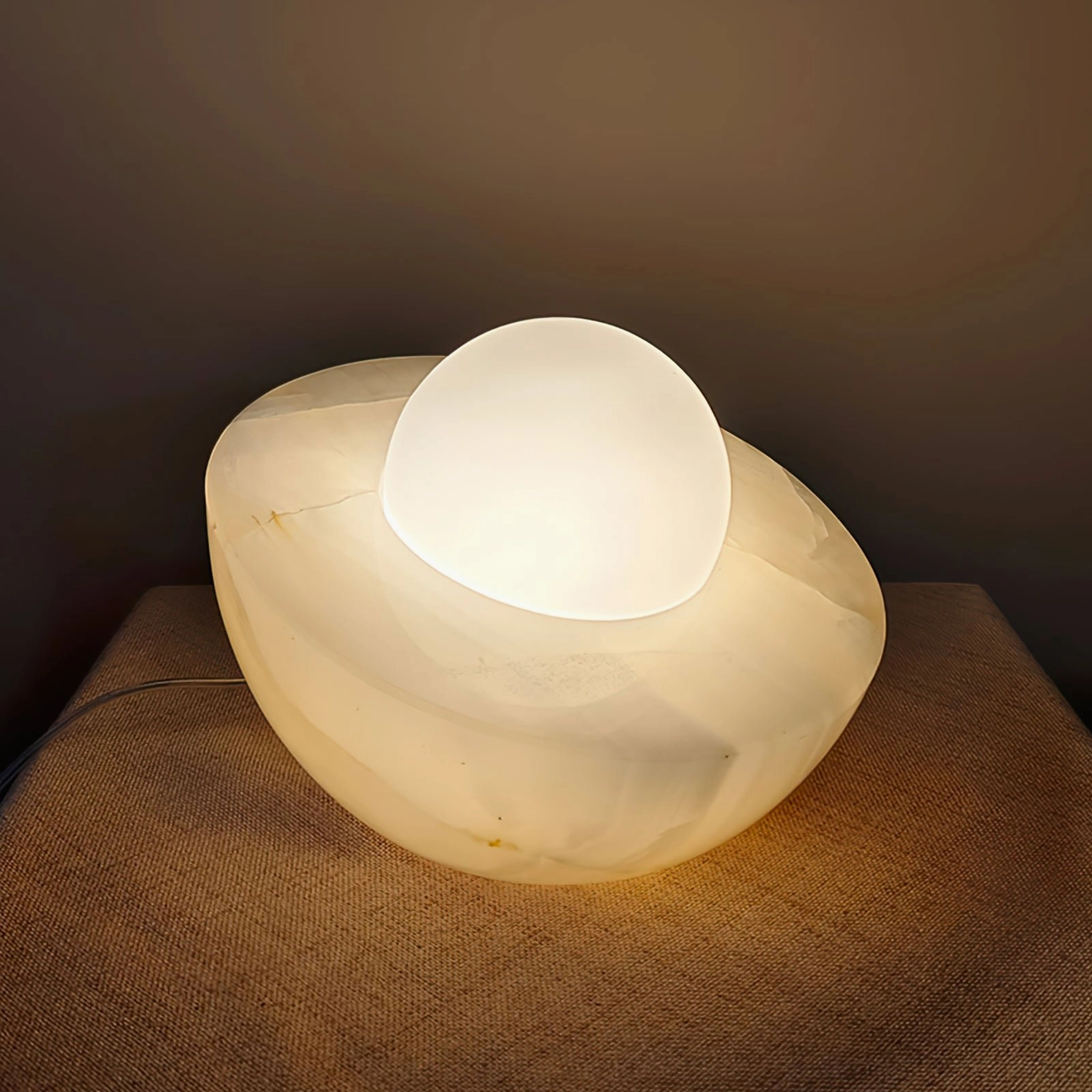 Piccola table lamp with natural marble base and frosted glass orb, soft diffused lighting, modern interior ambiance
