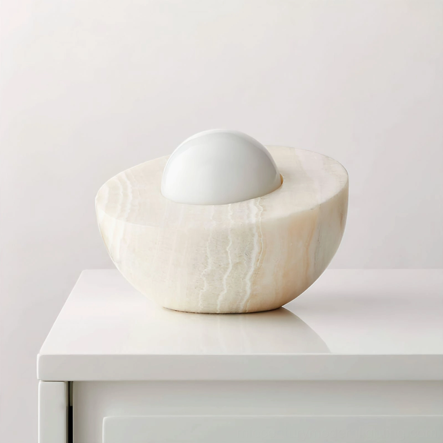 Piccola frosted glass orb lamp on white dresser, clear natural marble veining visible, minimalist modern lighting design