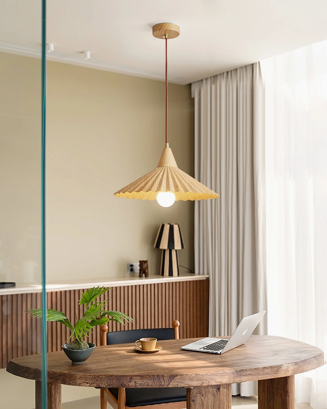 White Pieghe pendant lamp installation angle showing sculptural pleated design and light distribution pattern