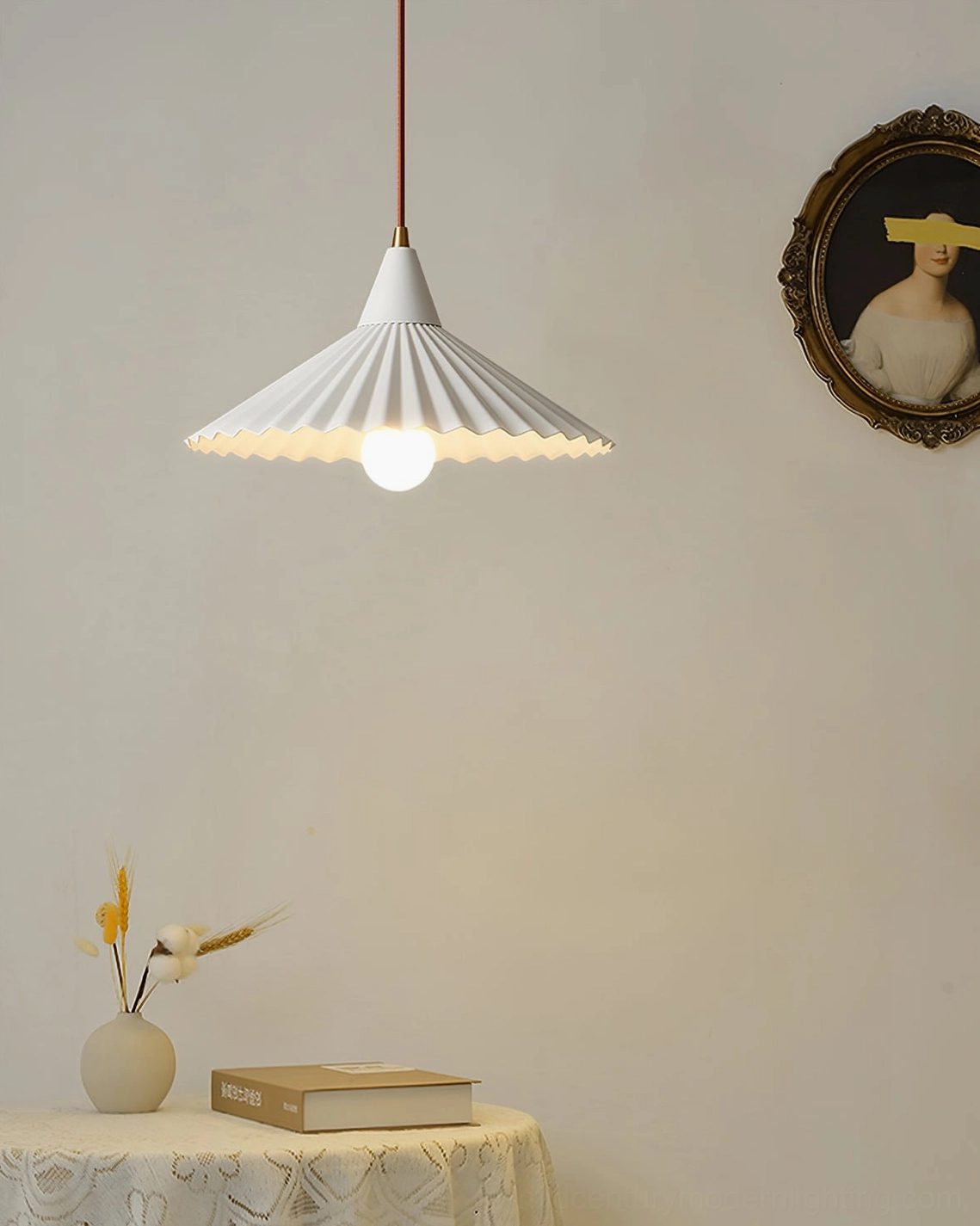 Pieghe pleated pendant lamp beside vintage round wall decor in minimalist home interior