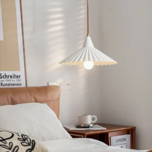 White Pieghe pendant lamp hanging in cozy Nordic bedroom with brown suspension cord and warm ambient lighting