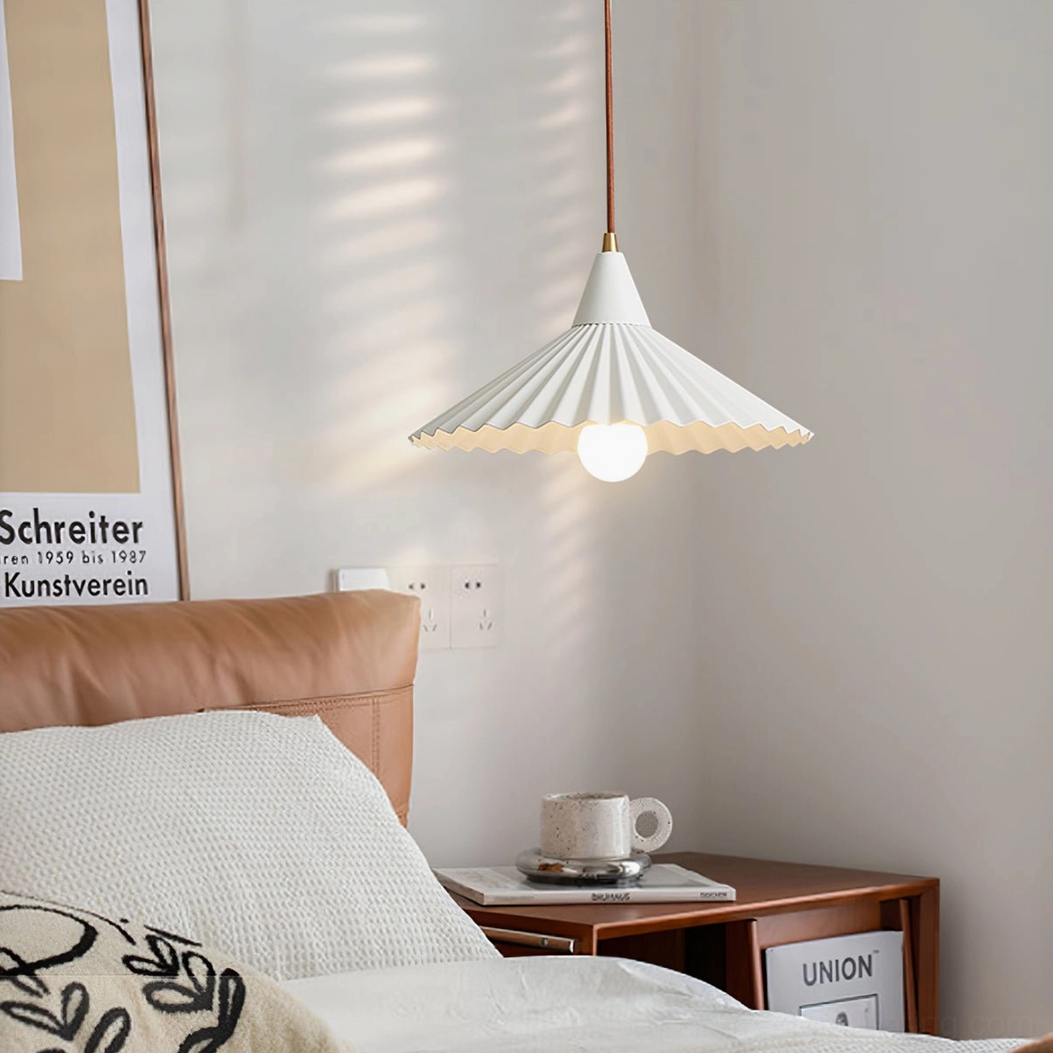 White Pieghe pendant lamp hanging in cozy Nordic bedroom with brown suspension cord and warm ambient lighting