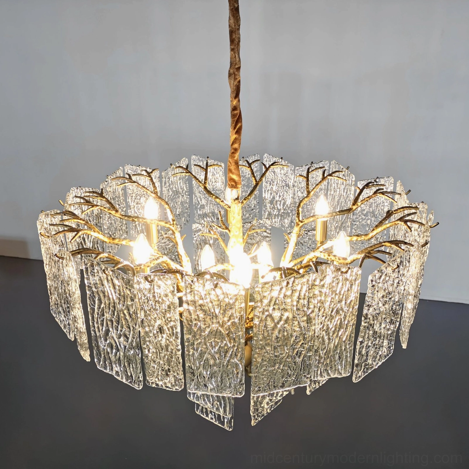 Piemonte chandelier brass frame architecture showing organic branching design and geometric glass tiers