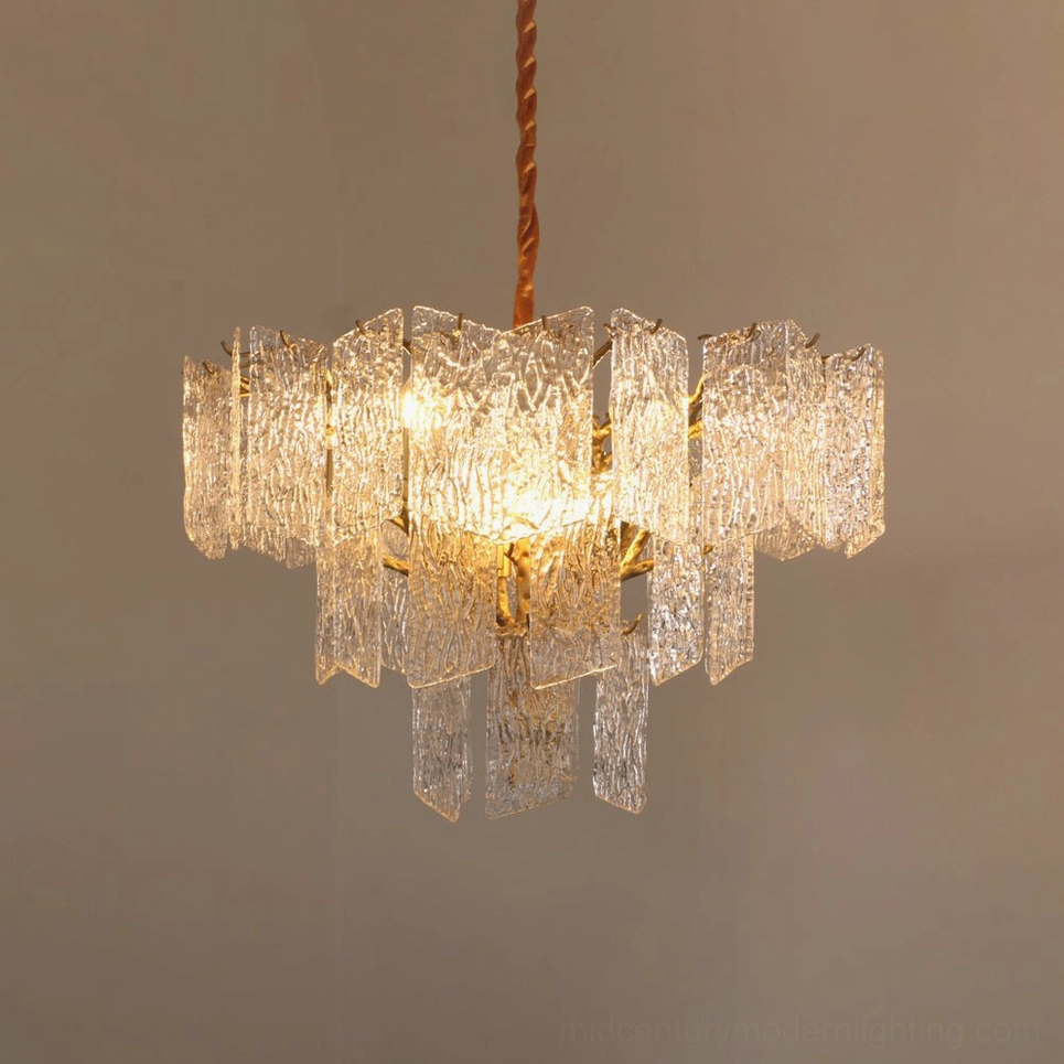 Piemonte chandelier featuring brass frame construction with tiered clear textured glass arrangement