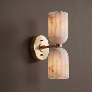 Close-up side view of Piermont alabaster wall sconce showing reeded fluted texture and matte brass mounting bracket