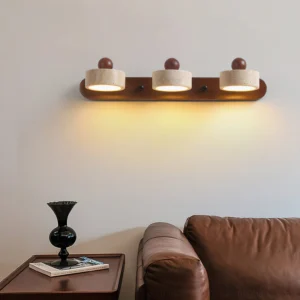 Piero 3-light travertine wall sconce in living room above leather sofa, mid-century modern decor