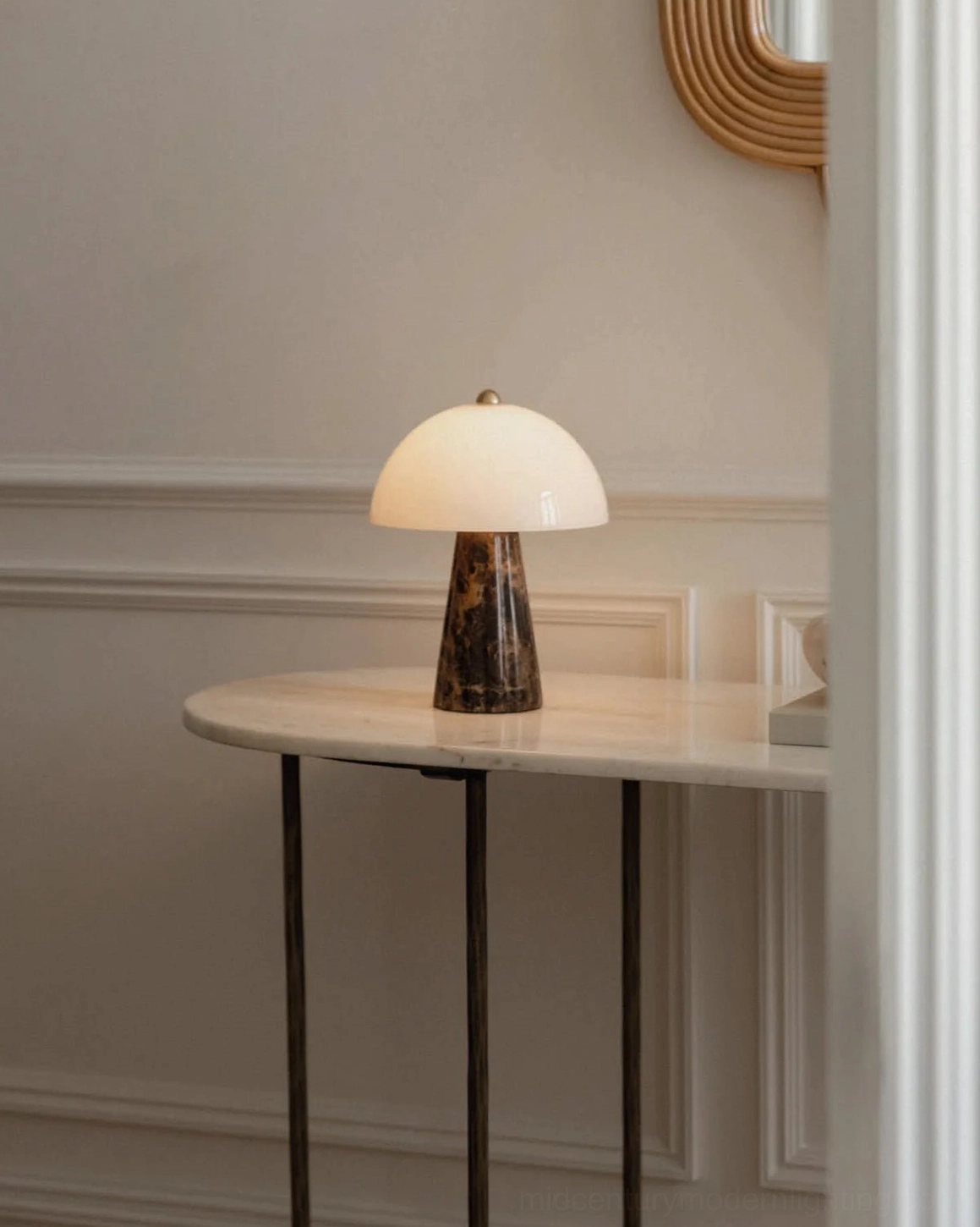 Compact sculptural Pierre table lamp in minimalist entryway with white dome shade and marble base on console