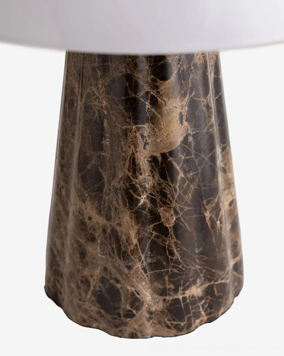 Close-up detail of Pierre lamp base showing natural dark brown marble veining with golden accents and brass finial