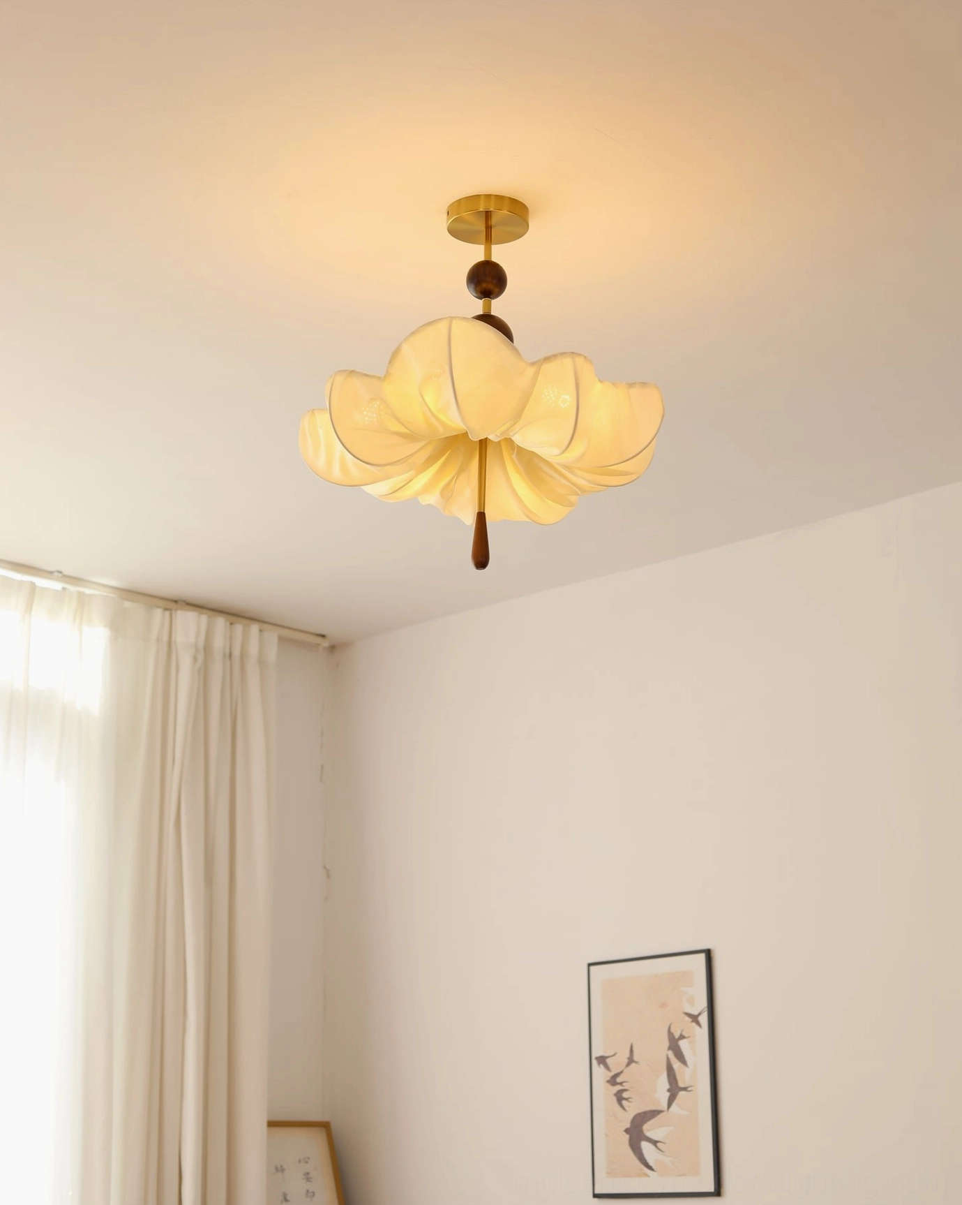 Lit Pinctada ceiling fixture in room with sheer curtain and wall art, vintage minimalist warm lighting
