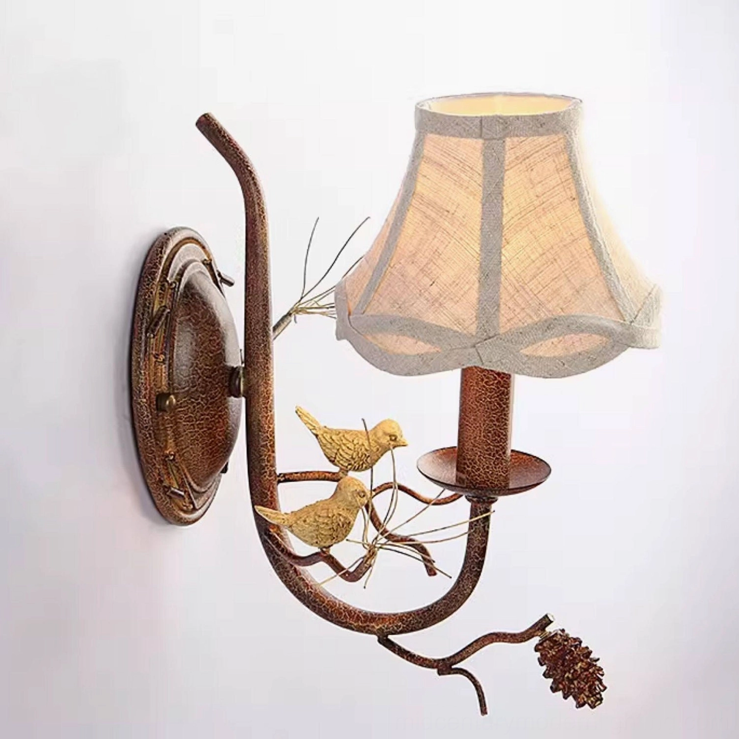 Bronze finish Pinecone Bird single-head wall lamp with warm fabric shade diffuser, side angle view