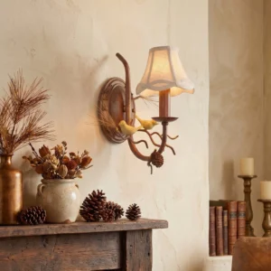 Double-head rustic bird wall lamp mounted beside fireplace with vintage decor and dried florals, warm ambient lighting