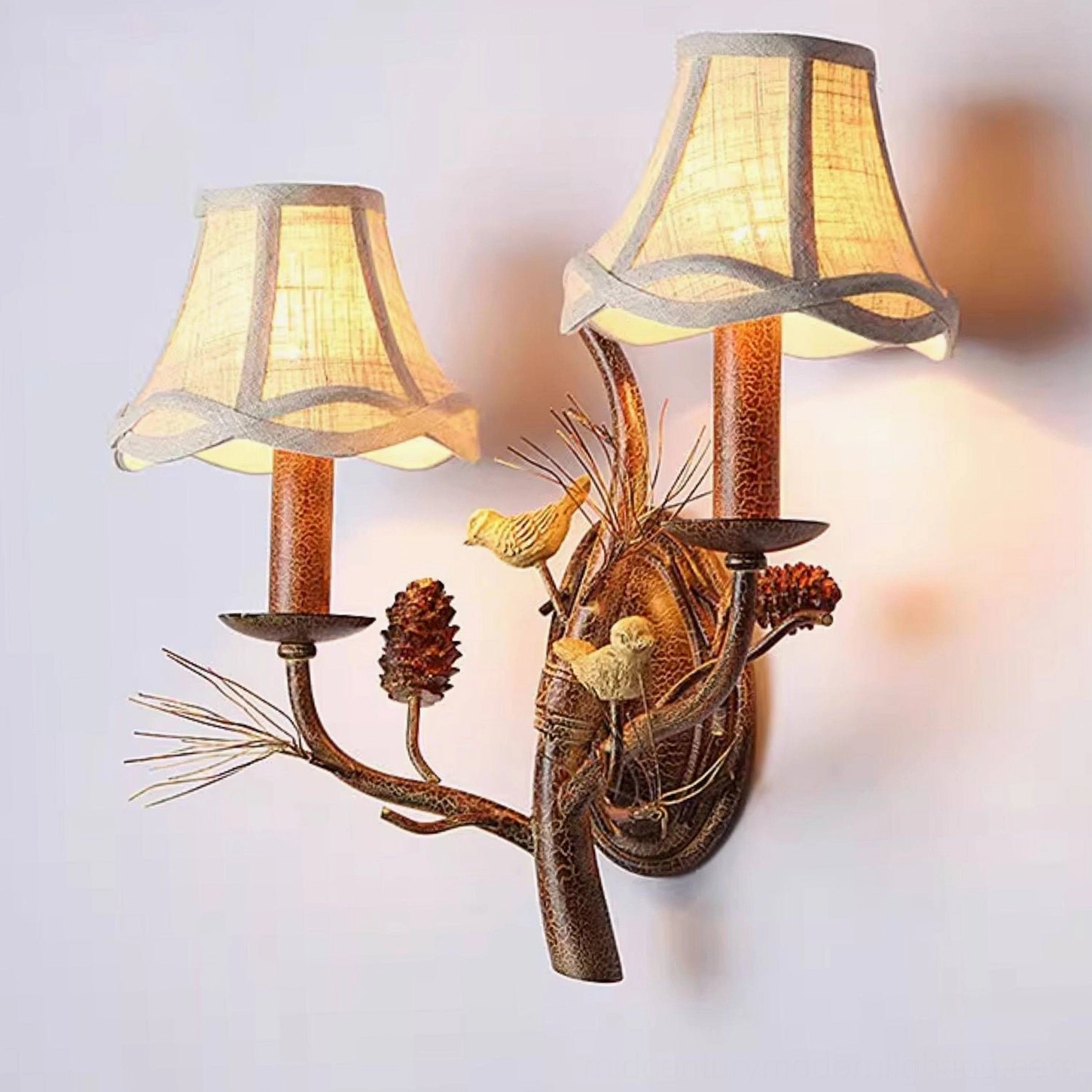 White finish Pinecone Bird wall lamp mounted on pale wall with Scandinavian modern home decor