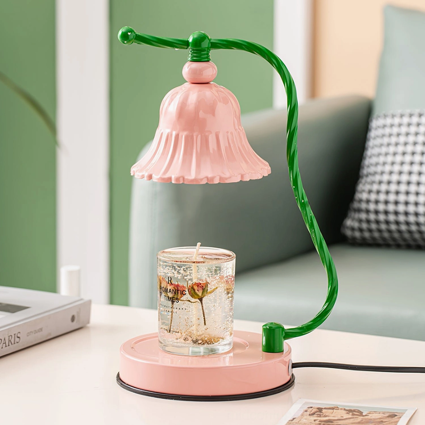Front three-quarter view of blush pink ceramic lamp on living room side table with rose flowers
