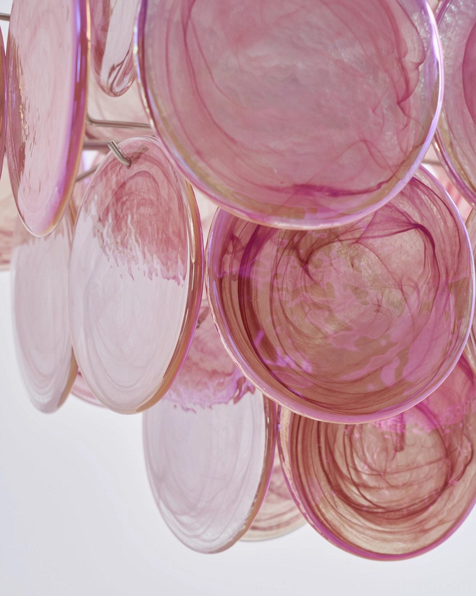 Macro overhead view of Ellie pink disc chandelier highlighting gradient marbled translucent glass texture and rounded disc details