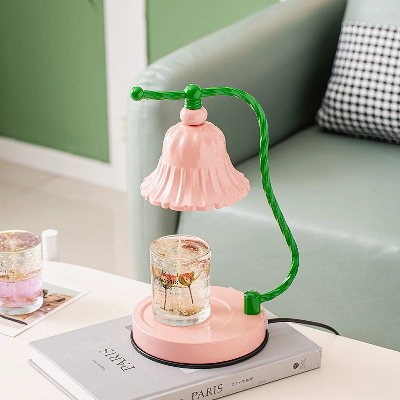 Blush pink table lamp with twisted green metal arm featuring non-slip rubber base detail