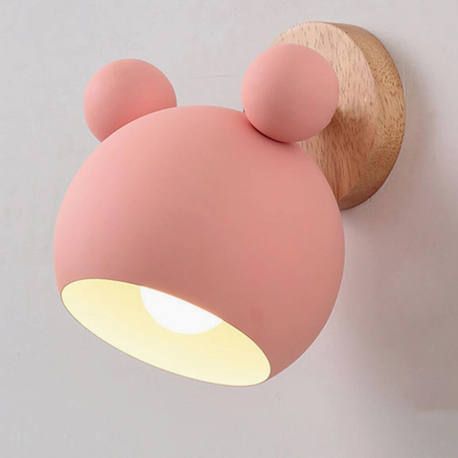 Pink mouse wall sconce with matte finish and visible mounting hardware detail