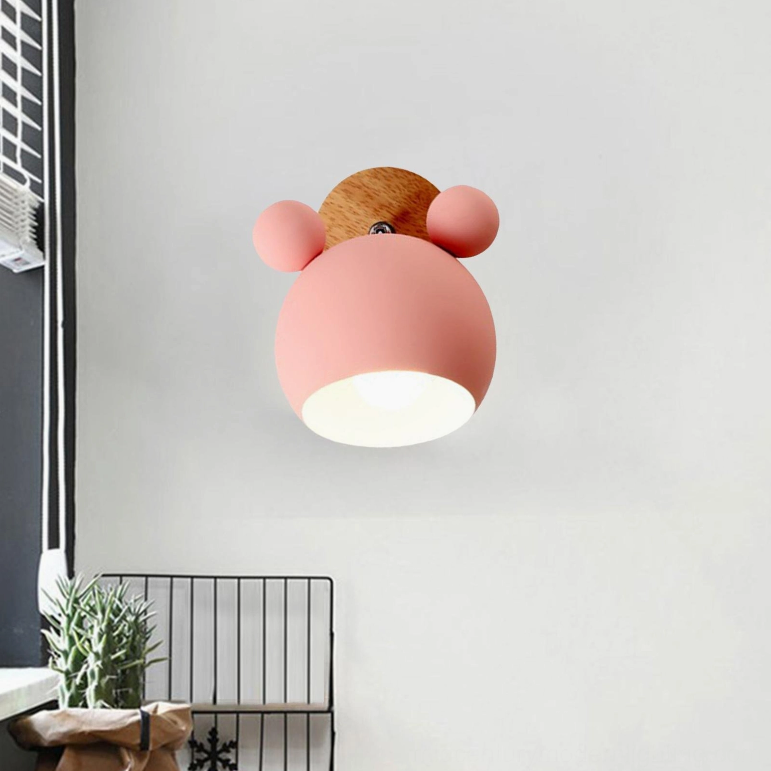 Pink mouse wall lamp installed in minimalist home corner with warm illumination