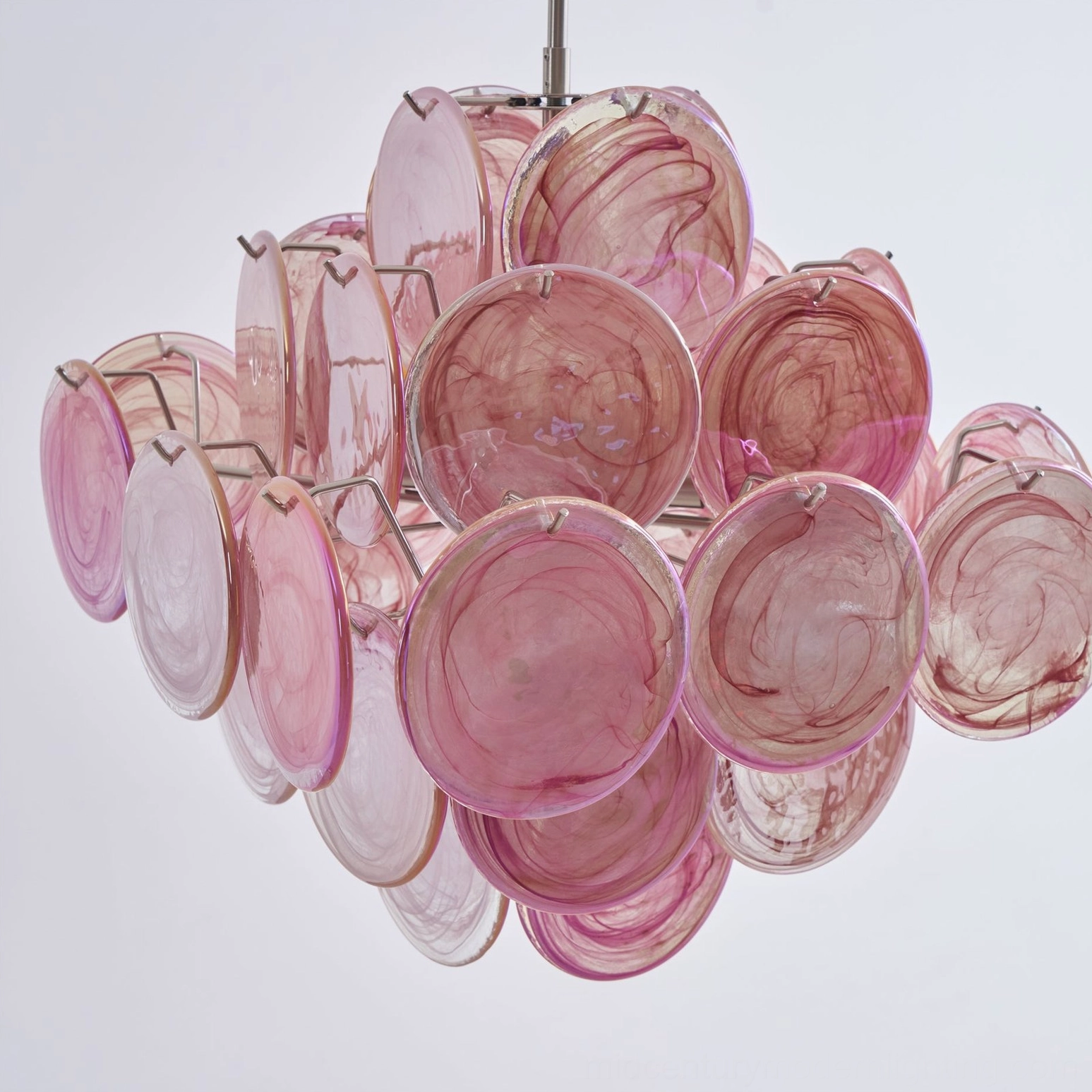 Pink Murano glass chandelier with swirled translucent glass discs and metal clip mount hardware detail