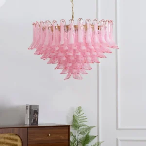 Pink Murano glass chandelier positioned at eye level in minimalist white room showcasing warm romantic glow and glass texture