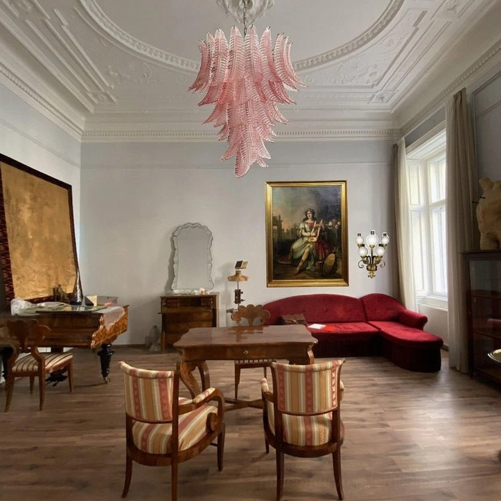 Luxury tiered glass chandelier paired with high ceiling in classic formal living room interior