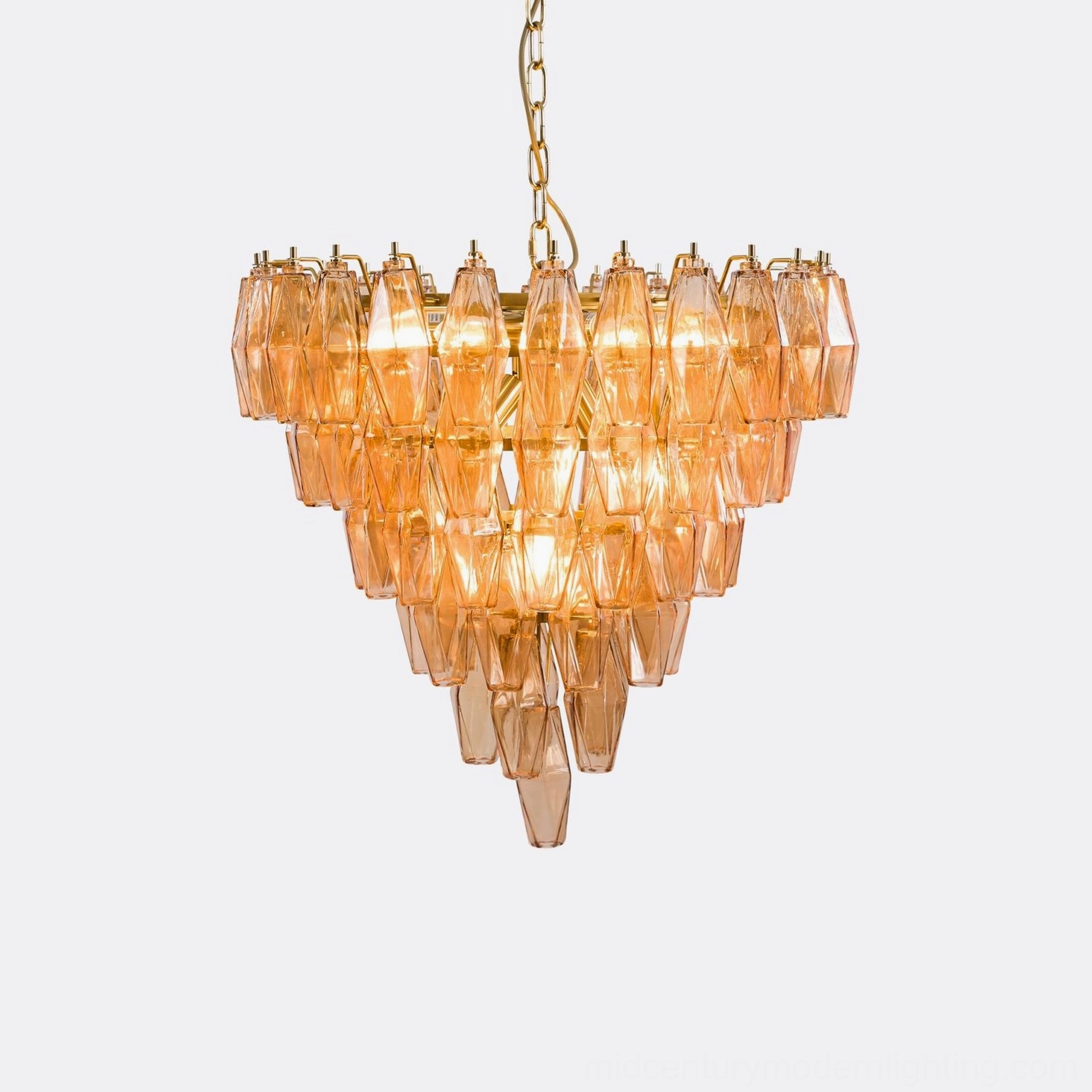 Pink tiered crystal chandelier showing prismatic refraction and brass frame