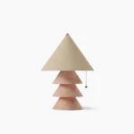 Pink marble pyramid table lamp with tiered stone base and beige fabric shade on white studio background