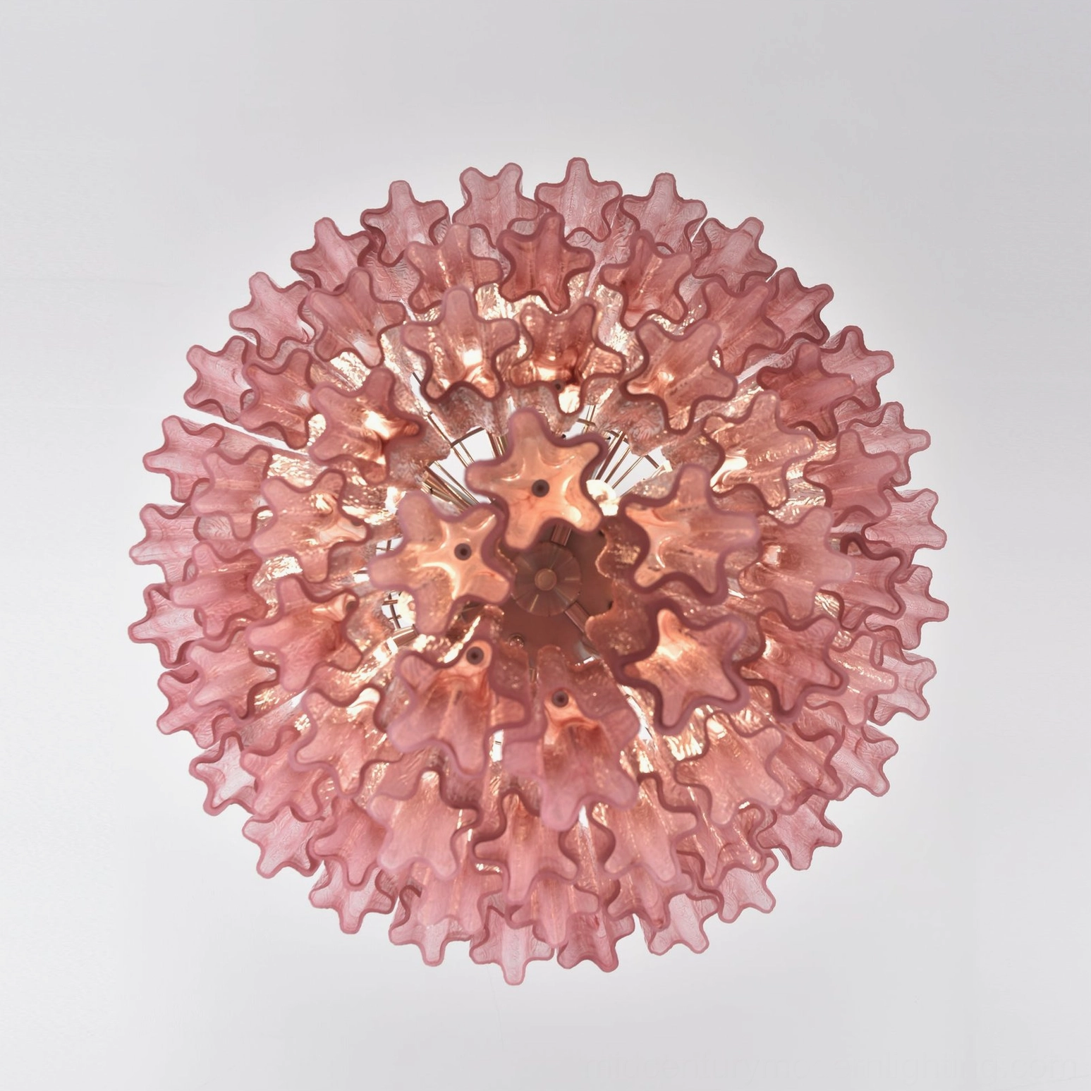 Pink ruffled disc glass chandelier bottom-up view wavy edge central metal fixture illuminated
