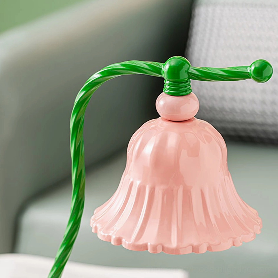 Blush pink ceramic table lamp with vintage-inspired design on styled bedroom nightstand