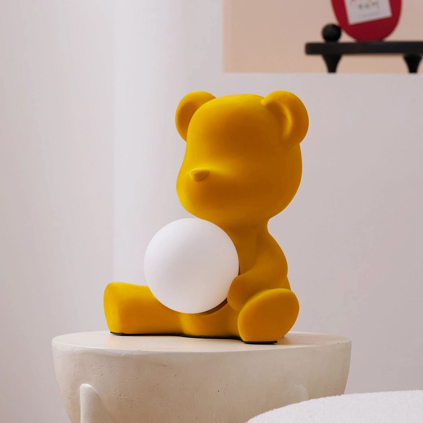 Pink teddy bear table lamp in soft focus demonstrating ambient lighting quality