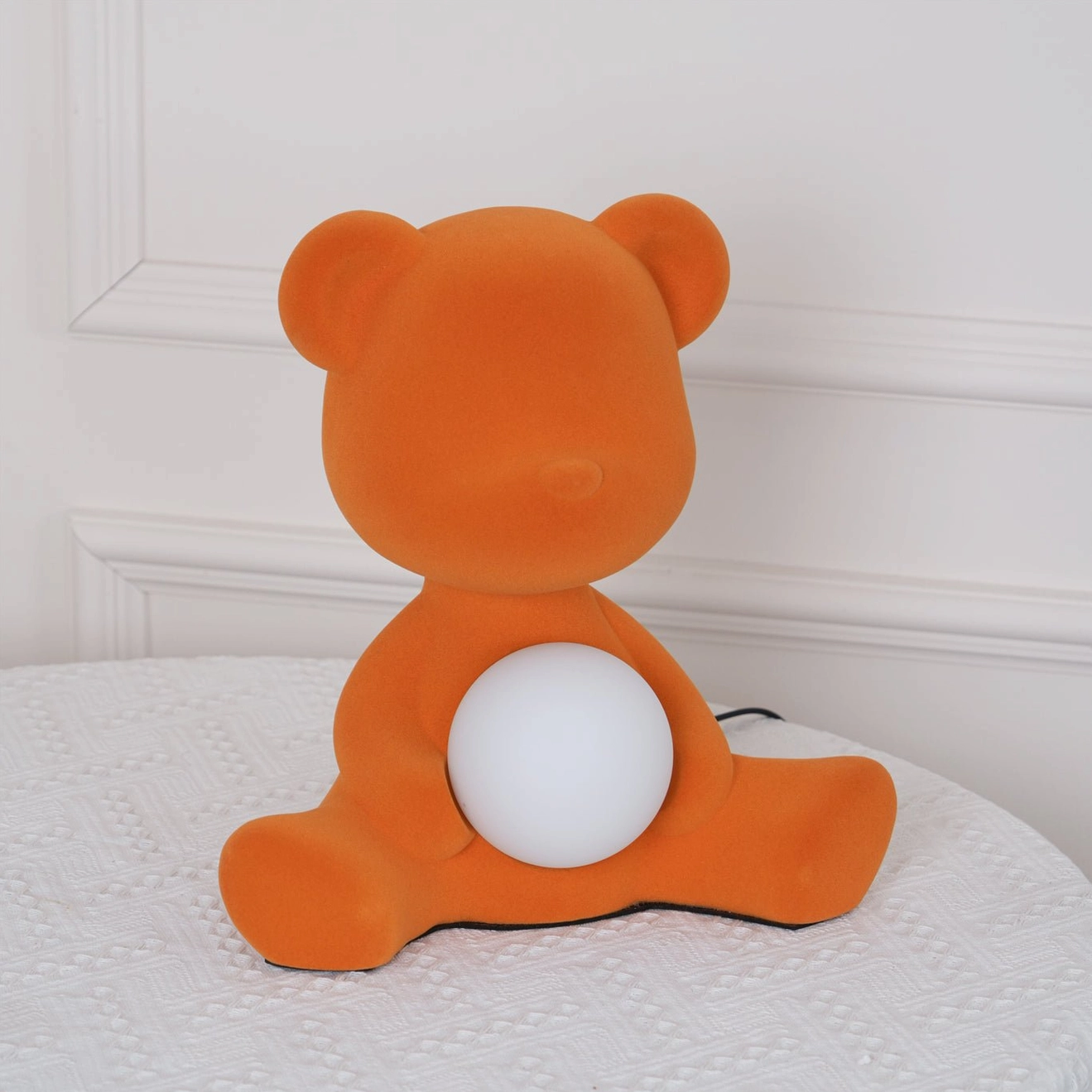 Pink teddy bear table lamp on white background showcasing soft finish