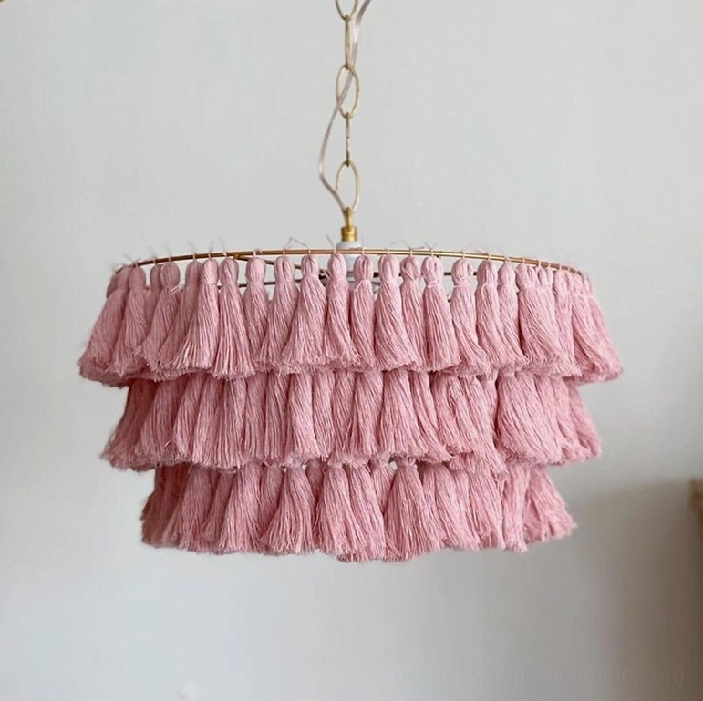 Pink tiered tassel chandelier with soft romantic aesthetic in bohemian interior styling context