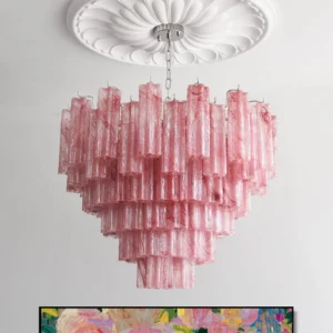 Pink Triedri chandelier installed overhead in luxury dining room with ceiling medallion, prismatic cascade lighting