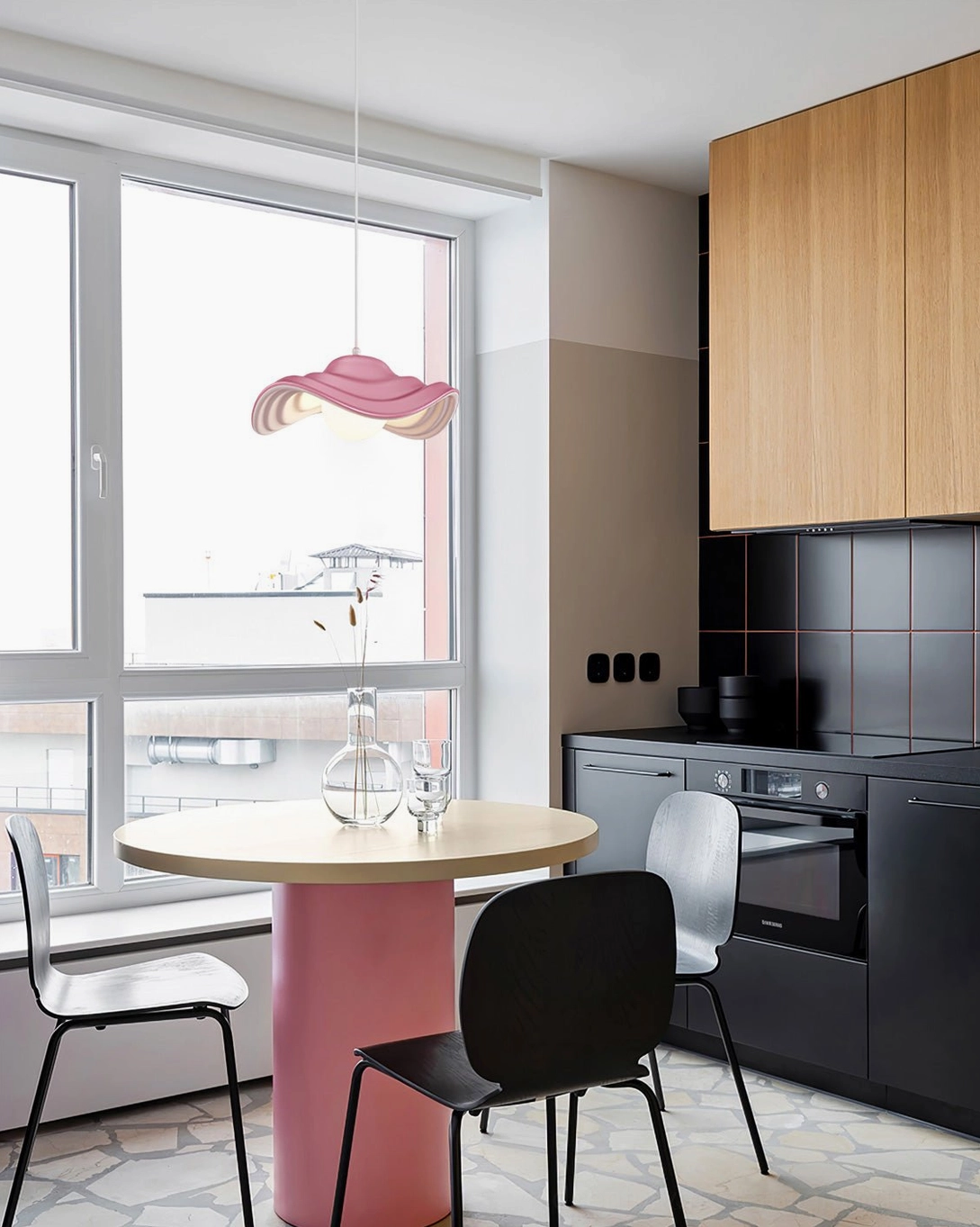 Blush pink wavy pendant lamp suspended in warm contemporary kitchen and dining space, creating inviting ambient light for residential interior