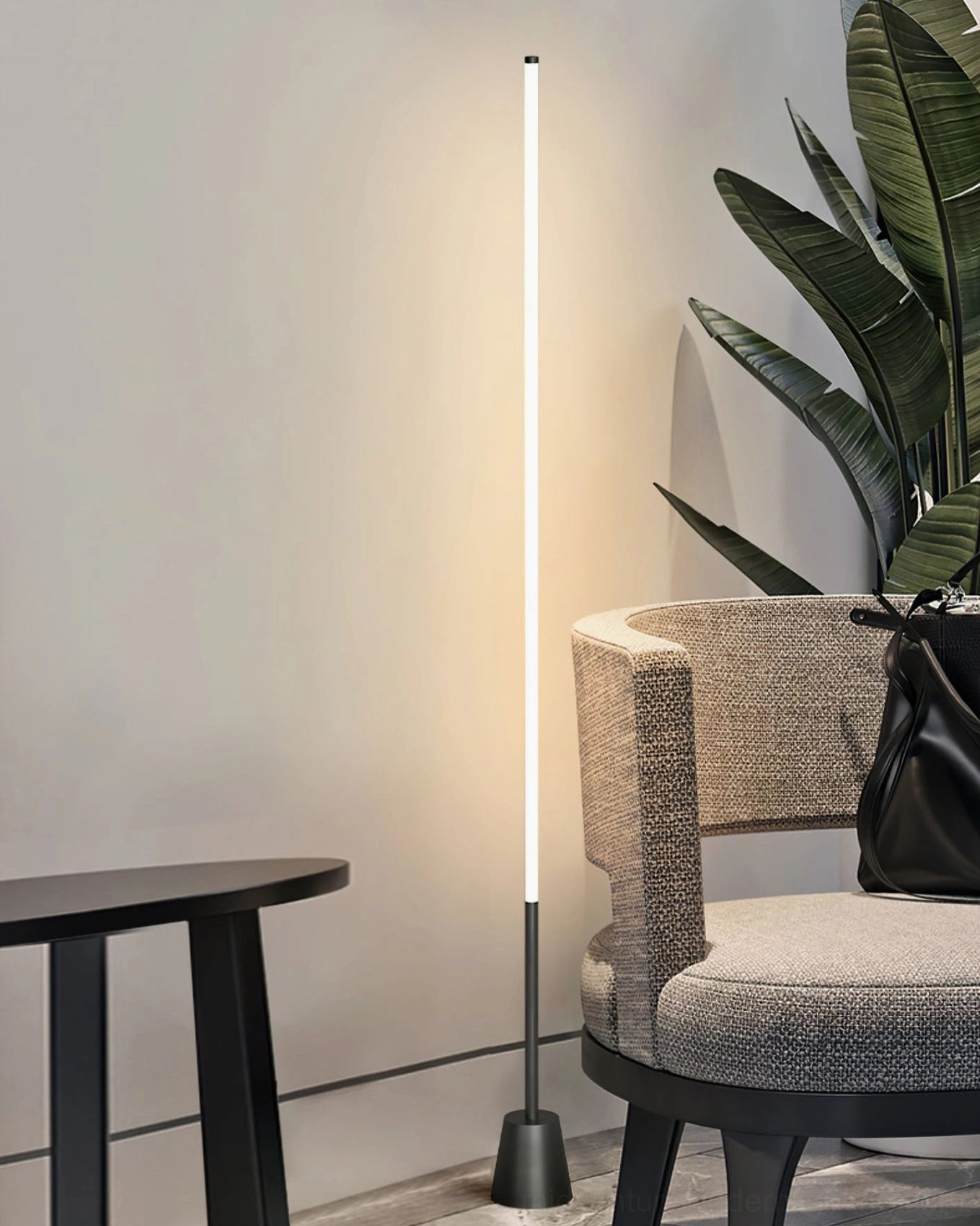 Minimalist LED floor lamp with black base in corner with green plants, contemporary accent lighting