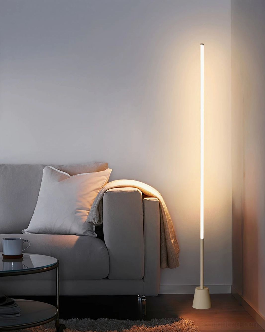 LED floor lamp with warm ambient glow in living room with grey fabric sofa, contemporary interior design