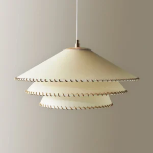 Close-up of Planas pendant lamp showing brass hanging hardware and fabric construction