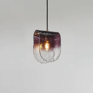 Modern pendant light side angle showing textured glass and exposed Edison bulb installation