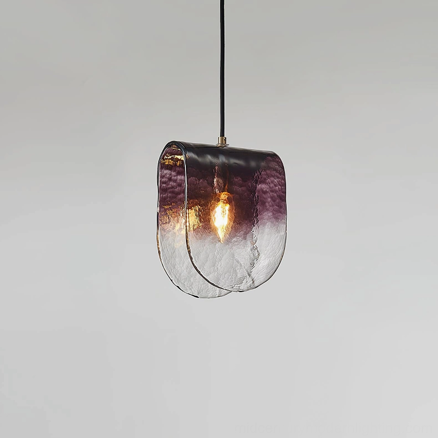 Modern pendant light side angle showing textured glass and exposed Edison bulb installation