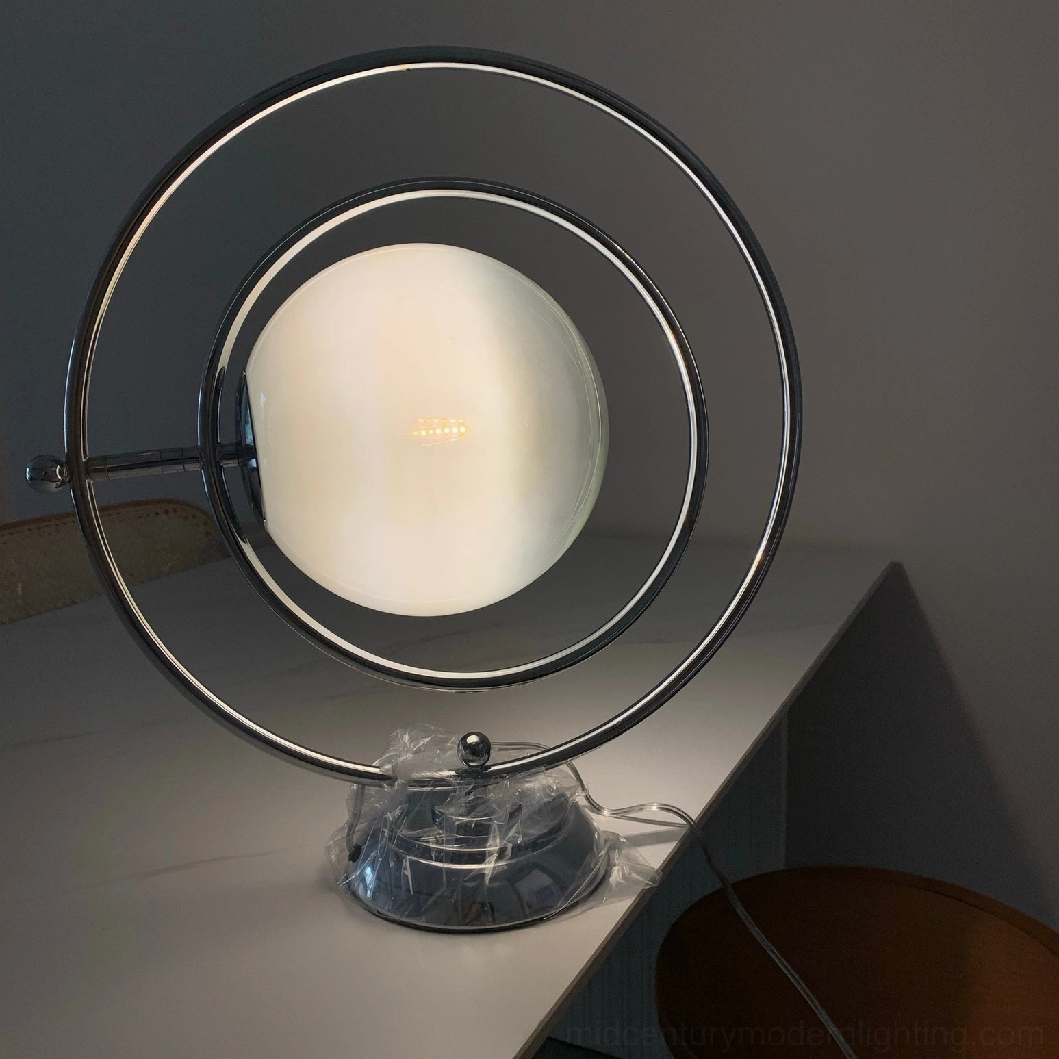 Planet table lamp creating warm home ambiance in minimalist living space