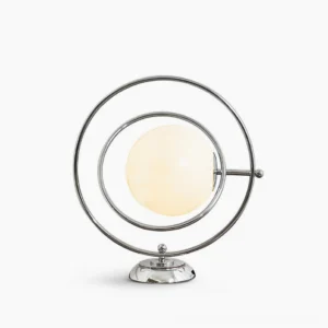 Rotating Planet table lamp with polished silver metal frame and frosted white glass globe on white studio background